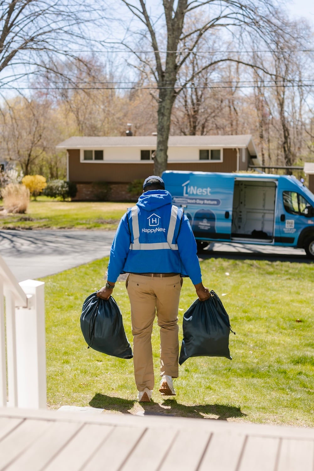 HappyNest driver picking up laundry bags